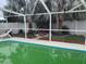 View of the backyard pool, surrounded by palm trees and landscaping at 1209 Croydonwood Cir, Brandon, FL 33510