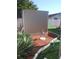 Backyard shed with a decorative flower bed and partial landscaping under a bright sky at 1209 Croydonwood Cir, Brandon, FL 33510