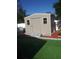 Outdoor shed with modern siding, complemented by fresh landscaping at 1209 Croydonwood Cir, Brandon, FL 33510