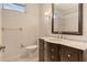 A clean, well-lit bathroom featuring a modern vanity with a marble countertop, white tiles, and simple fixtures at 12113 Whistling Way, Lakewood Ranch, FL 34202