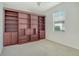 Inviting bedroom features built-in bookshelves and a window with natural lighting at 12113 Whistling Way, Lakewood Ranch, FL 34202