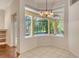 Bright dining area features a bay window overlooking a screened patio and lush landscaping at 12113 Whistling Way, Lakewood Ranch, FL 34202
