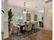 Elegant dining room featuring a chandelier, large window, and a mirrored wall at 12113 Whistling Way, Lakewood Ranch, FL 34202