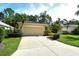 Single Gathering home featuring mature landscaping, a long driveway, and attached two-car garage at 12113 Whistling Way, Lakewood Ranch, FL 34202