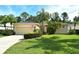 Lovely home with a well-maintained lawn, mature trees, and a paved driveway leading to a two-car garage at 12113 Whistling Way, Lakewood Ranch, FL 34202