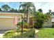 Beautiful single-story home with lush landscaping, green lawn, and an American flag waving at 12113 Whistling Way, Lakewood Ranch, FL 34202