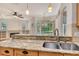 Kitchen overlooks a breakfast bar area with stainless steel sink and granite countertops at 12113 Whistling Way, Lakewood Ranch, FL 34202