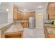 Spacious kitchen boasts granite countertops, stainless steel appliances, and wood cabinetry at 12113 Whistling Way, Lakewood Ranch, FL 34202