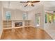 Bright living area featuring a fireplace, built-in shelves, and a sliding door to the outdoor patio at 12113 Whistling Way, Lakewood Ranch, FL 34202