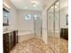 Beautiful main bathroom with dual vanities, a soaking tub, and glass-enclosed shower at 12113 Whistling Way, Lakewood Ranch, FL 34202