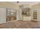 A covered patio with brick flooring and view to living spaces through french doors at 12113 Whistling Way, Lakewood Ranch, FL 34202