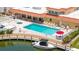Community pool area featuring a hot tub, lounge chairs, and boat docks for waterfront living at 1257 S Portofino Dr # 306, Sarasota, FL 34242