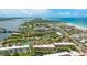 Aerial view of waterfront condo community with boat docks, tennis courts, and bay views at 1257 S Portofino Dr # 306, Sarasota, FL 34242