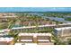 Aerial view of waterfront condo community with boat docks, lush landscaping, and beautiful water views at 1257 S Portofino Dr # 306, Sarasota, FL 34242