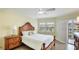 Relaxing bedroom features a Queen bed, wood floors and natural light at 1257 S Portofino Dr # 306, Sarasota, FL 34242
