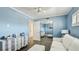 Bright bedroom featuring a blue accent wall, closet with mirrored sliding doors, and light striped furniture at 1257 S Portofino Dr # 306, Sarasota, FL 34242