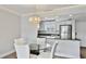 Cozy dining area with modern chandelier and stainless appliances with granite countertops in the kitchen at 1257 S Portofino Dr # 306, Sarasota, FL 34242