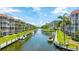 Beautiful waterfront condominiums with boat docks, surrounded by lush landscaping and blue skies at 1257 S Portofino Dr # 306, Sarasota, FL 34242