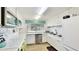 Bright kitchen featuring white cabinetry, tile backsplash, stainless steel appliances, and functional layout at 1257 S Portofino Dr # 306, Sarasota, FL 34242