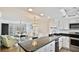 Bright, open-concept kitchen with granite countertops and stainless steel appliances overlooking the living area at 1257 S Portofino Dr # 306, Sarasota, FL 34242