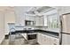 Updated kitchen featuring stainless steel appliances, granite countertops, and white cabinets at 1257 S Portofino Dr # 306, Sarasota, FL 34242