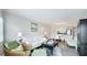 Cozy living room featuring a white couch, wood floors and an open concept leading to dining area at 1257 S Portofino Dr # 306, Sarasota, FL 34242