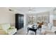 Well-lit living room with a balcony, comfortable seating, and a black entertainment center at 1257 S Portofino Dr # 306, Sarasota, FL 34242