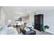 Bright living room featuring hardwood floors, a ceiling fan and open floor plan flowing into the kitchen at 1257 S Portofino Dr # 306, Sarasota, FL 34242