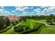 Aerial view of a large estate with manicured lawns, a golf course, and a waterfront view on a sunny day at 14312 Crimson Ave, Bradenton, FL 34211
