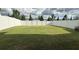 Spacious backyard with a lush green lawn and a tall white privacy fence at 14312 Crimson Ave, Bradenton, FL 34211