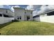 Large, fenced backyard featuring well maintained lawn and sliding glass door access to the home at 14312 Crimson Ave, Bradenton, FL 34211