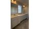 Bathroom with dual vanities, white cabinets, and framed mirrors above at 14312 Crimson Ave, Bradenton, FL 34211