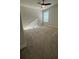 Bright, carpeted bedroom featuring a ceiling fan and a window with natural light at 14312 Crimson Ave, Bradenton, FL 34211