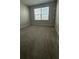 A comfortable bedroom with light carpet and a window at 14312 Crimson Ave, Bradenton, FL 34211
