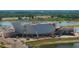 Aerial view of a large construction site featuring a modern building, construction equipment, and a waterfront at 14312 Crimson Ave, Bradenton, FL 34211