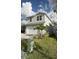 Two-story home with a well-manicured front yard, tropical palm tree and paved driveway at 14312 Crimson Ave, Bradenton, FL 34211