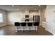 Modern kitchen featuring white cabinets, granite countertops, a large island, and stainless steel appliances at 14312 Crimson Ave, Bradenton, FL 34211