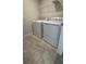 Practical laundry area with washer, dryer, tile flooring and wire shelving at 14312 Crimson Ave, Bradenton, FL 34211