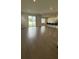 Open-concept living room features wood floors, recessed lighting, and a sliding glass door leading to the backyard at 14312 Crimson Ave, Bradenton, FL 34211