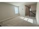 Loft area with neutral carpet, a window, and a view of the staircase at 14312 Crimson Ave, Bradenton, FL 34211