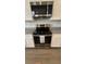 Stainless steel electric range with granite countertops and white cabinets in a well-lit kitchen area at 14312 Crimson Ave, Bradenton, FL 34211