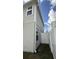 Narrow side yard with gate and exterior access point to the back yard at 14312 Crimson Ave, Bradenton, FL 34211