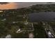 Magnificent aerial view of the property highlighting its serene lakeside location and verdant surroundings at 1610 Bayshore Dr, Terra Ceia, FL 34250
