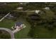 Aerial shot of stilt home surrounded by lush landscapes at 1610 Bayshore Dr, Terra Ceia, FL 34250