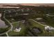 Aerial view of a community of homes in a waterfront setting at dusk at 1610 Bayshore Dr, Terra Ceia, FL 34250