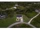 Aerial view of home surrounded by trees and neighboring houses at 1610 Bayshore Dr, Terra Ceia, FL 34250