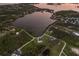 Stunning aerial view of waterfront property with lush surroundings and serene lake access at 1610 Bayshore Dr, Terra Ceia, FL 34250