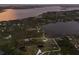 Expansive aerial perspective showcasing waterfront property with serene lake views and mature landscaping at 1610 Bayshore Dr, Terra Ceia, FL 34250