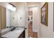 Bathroom showcases a modern vanity with granite countertop and a door leading to another room at 1610 Bayshore Dr, Terra Ceia, FL 34250