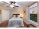 Bedroom with a queen-sized bed, a large window, and a ceiling fan at 1610 Bayshore Dr, Terra Ceia, FL 34250